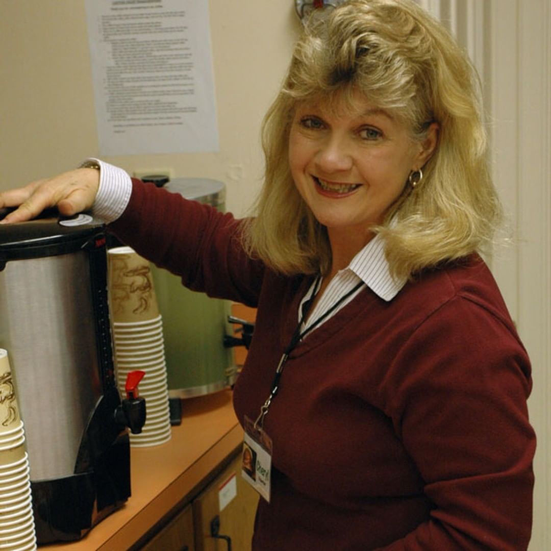 Cheryl, one of our happy volunteers, gets the coffee ready, in this vintage photo. She'll be at it again this Saturday, Nov 17, 2018 for Bill Staines!